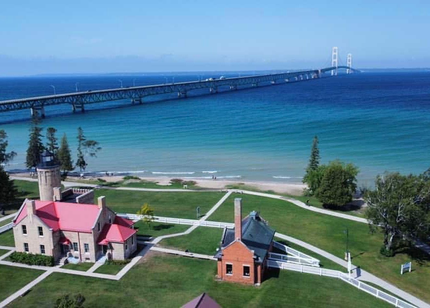 Arial view of Mackinaw Bridge, sapphire blue water, and park, taken over Parkside Inn